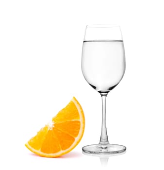 Glass of water and Half orange fruit on white background