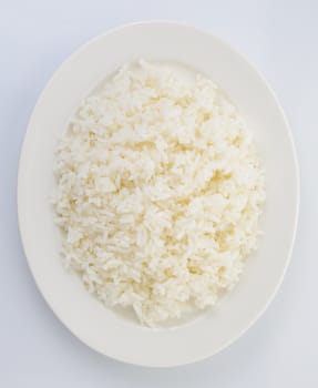 Cooked rice in a white plate on white background