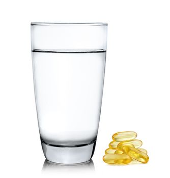 Glass of water and fish oil isolated on white background
