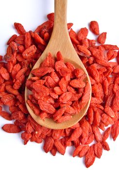 dry red goji berries  in the spoon on white background