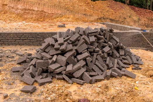 group of red bricks Inside building with construction unfinished.