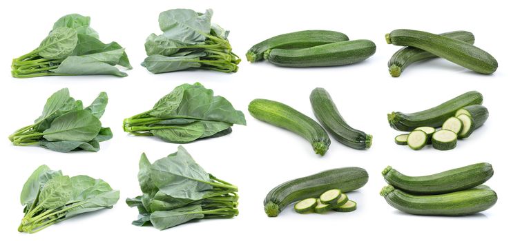 chinese broccoli and fresh zucchini isolated on white background