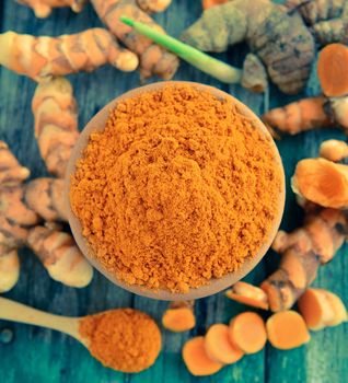 turmeric roots in the basket on wooden table