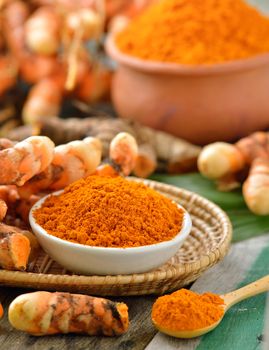 turmeric roots in the basket on wooden table