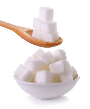 sugar cube in the spoon and bowl on white background