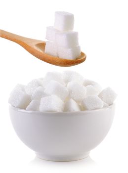 sugar cube in the bowl and wood spoon on white background