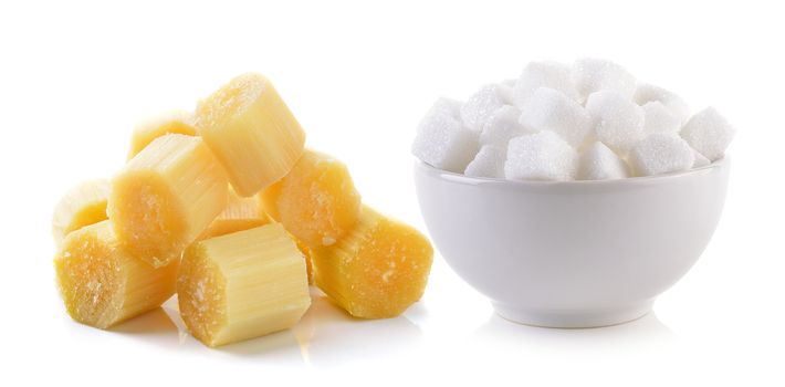 sugar cube in the bowl and sugarcane on white background
