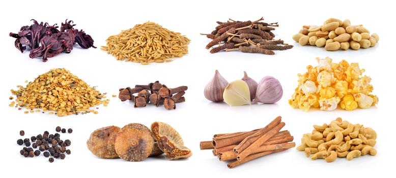 Dried figs, pepper corn, chili seeds, Spice cloves, rice grains, Dried okra, cashewnuts, peanuts, garlic, PopCorn, cinnamon on white background