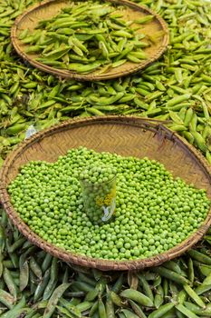 Green peas, Pisum sativum, being sold at traditional local food market.