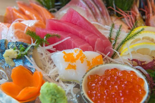 Salmon raw sashimi sushi with shrimp on plate, japanese food.