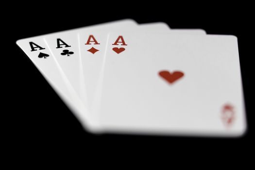 Playing Card Aces Close Up on black background.