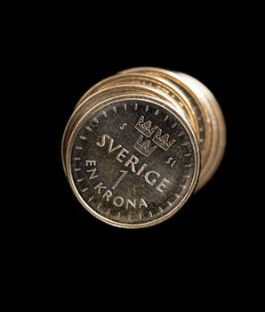 Swedish One Coins Stacked on Black Background.