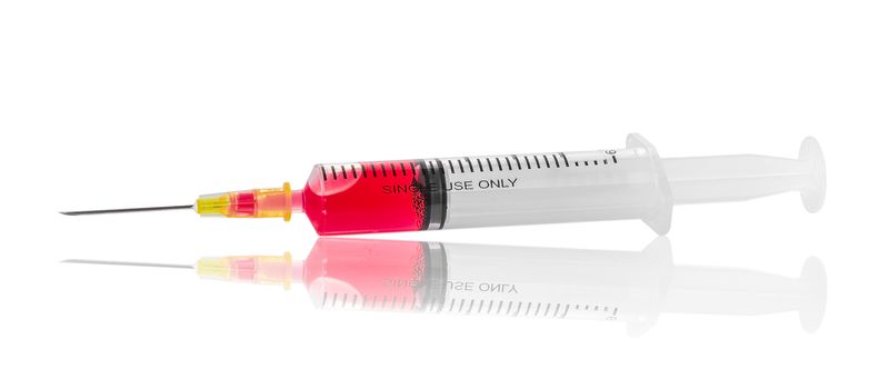 Medical syringe with red liquid isolated on white background