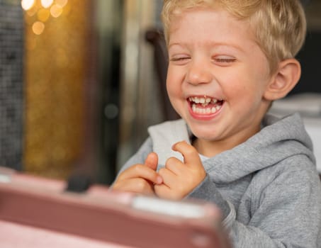 Baby boy sitting in high chair plays and smiling happiness at chinese restaurant.Natural light background with nice bokeh,horizontal photo.