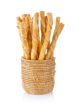 pile of delicious pretzel sticks in basket isolated on white background