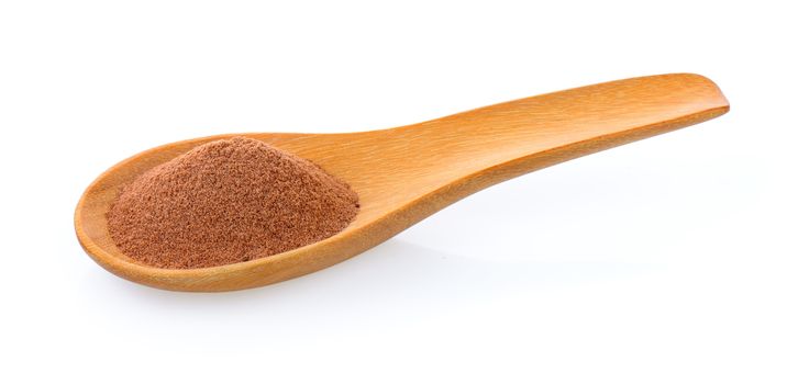 malt extract in wood spoon on white background