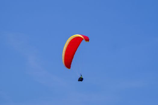 Paraglider in the blue sky at the Kampenwand in Bavaria, Germany