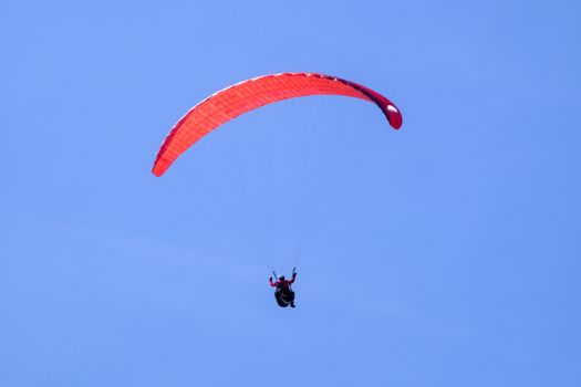 Paraglider in the blue sky at the Kampenwand in Bavaria, Germany