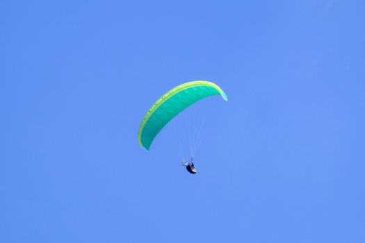 Paraglider in the blue sky at the Kampenwand in Bavaria, Germany