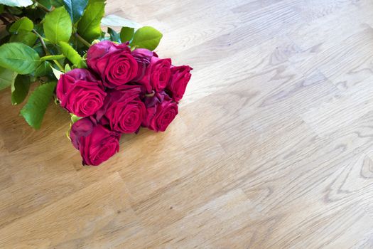 Red roses on a wooden table