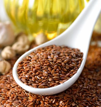 Flax seeds in spoon on table