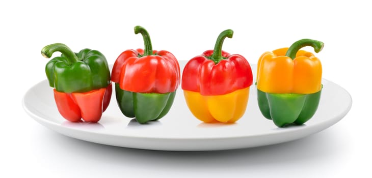 red and green pepper in a plate isolated on a white background