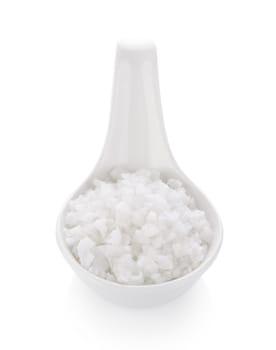 salt in spoon on white background