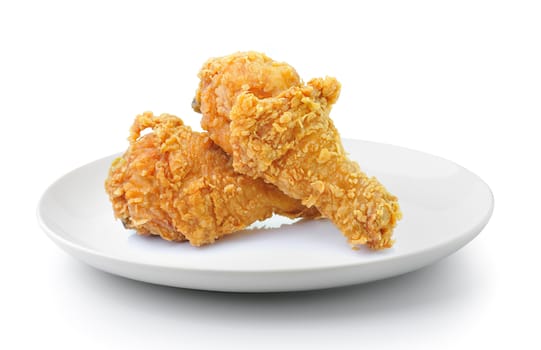 fried chicken drumsticks in plate isolated on a white background