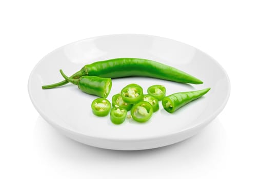 Green hot chili pepper in plate on white background