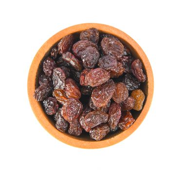 Black raisin on wood bowl isolated on white background