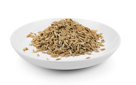 cumin seeds in plate on white background