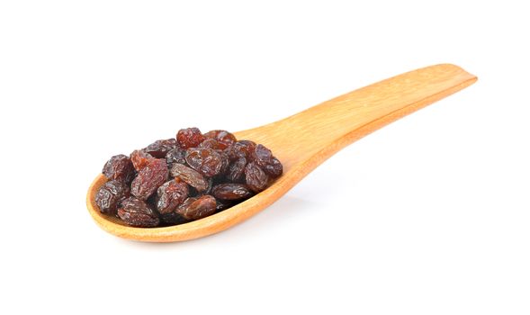 raisin in wood spoon isolated on white background