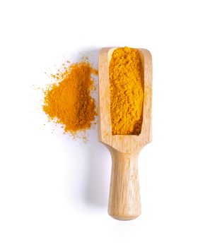 Turmeric (Curcuma) powder pile in wood scoop isolated on white background, top view