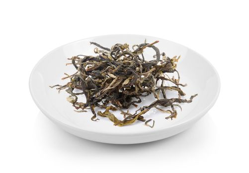 dry green tea in plate on white background
