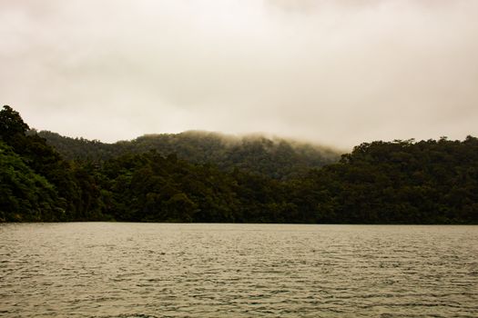 Two identical mountain lakes that are on top of the mountains on the island of Negros. Fog.
