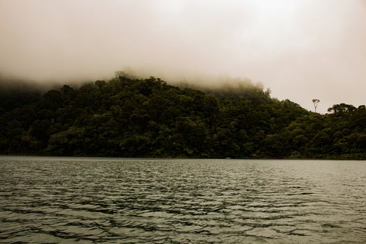 Two identical mountain lakes that are on top of the mountains on the island of Negros. Fog.