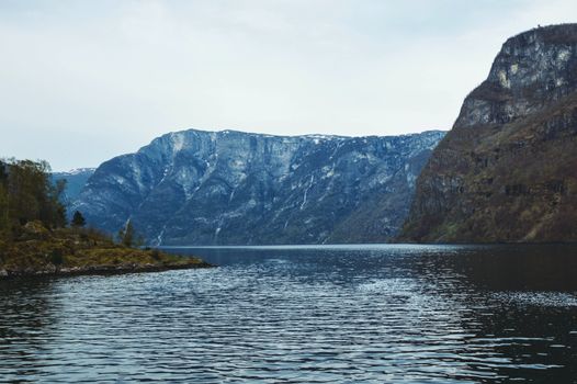 Flam, Norway, Europe. Beautiful Norwegian countryside with reflection of the mountains on the river