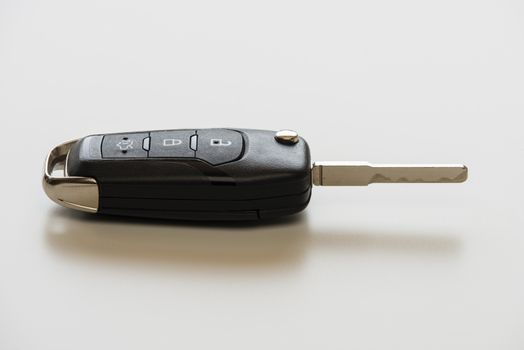 Close up of Remote electronic car key with mechanical second opening on white background.