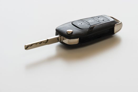 Close up of Remote electronic car key with mechanical second opening on white background.