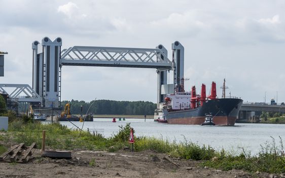 Botlek Bridge in the Rotterdam harbor area. The Botlek bridge is a combined lift over the Old Maas river, open to let a ship throughin the harbor of Rotterdam, famous by a lot of malfunction of it,
