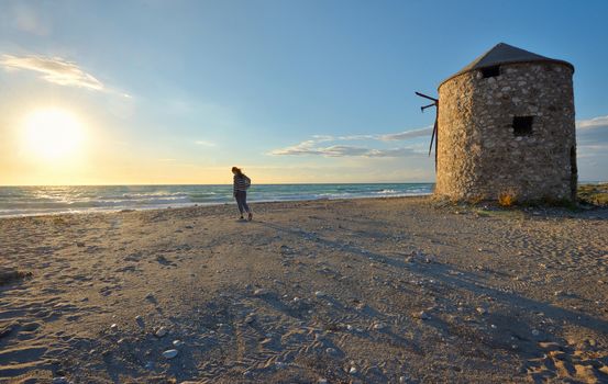 Young girl on the sunset beach in Lefkada