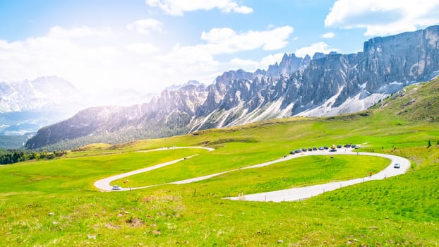 Mountain asphalt road serpentines in Dolomites on sunny summer day, Italy.