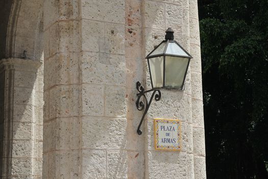 Street sign on a gray stone wall in Havana