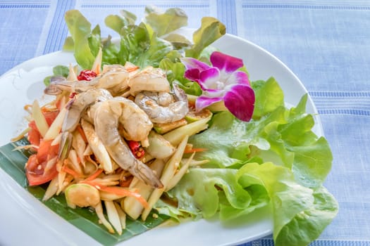 Traditional thai cuisine spicy green papaya salad with shrimp