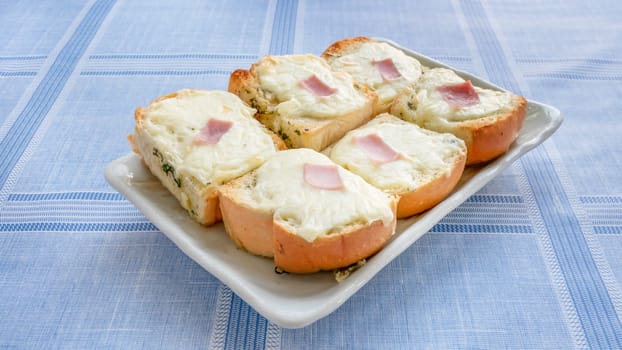 fresh homemade bread with garlic, cheese and herbs on plate