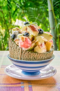 Colorful of fresh fruit salad in melon bowl