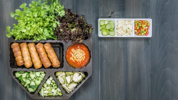 top view of roasted pork served with spicy sauce and vegetable (Nam Neung) on wooden background