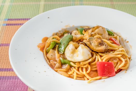 Spicy Spaghetti with Seafood On White Plate