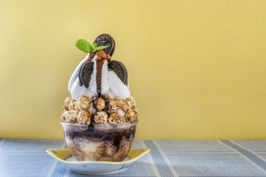 Bingsu - Korean shaved ice dessert with sweet toppings with chocolate cookies and popcorns