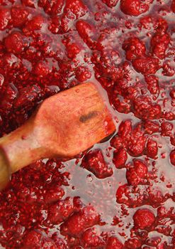 Red mass of the fresh jam from raspberry